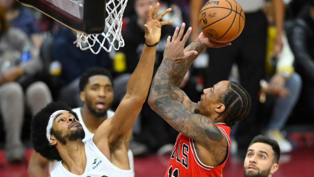 Jan 15, 2024; Cleveland, Ohio, USA; Chicago Bulls forward DeMar DeRozan (11) shoots beside Cleveland Cavaliers center Jarrett Allen (31) in the fourth quarter at Rocket Mortgage FieldHouse.